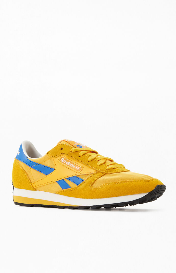 blue and yellow reebok classic