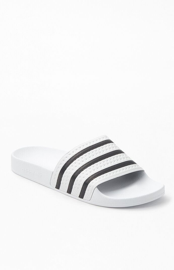 white and silver adidas sliders