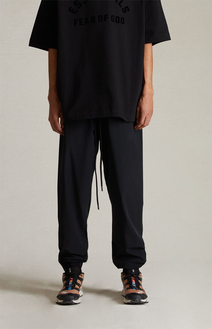 Fear of God Essentials Jet Black Nylon Track Pants | PacSun Fear of God Essentials Jet Black Nylon Track Pants | PacSun