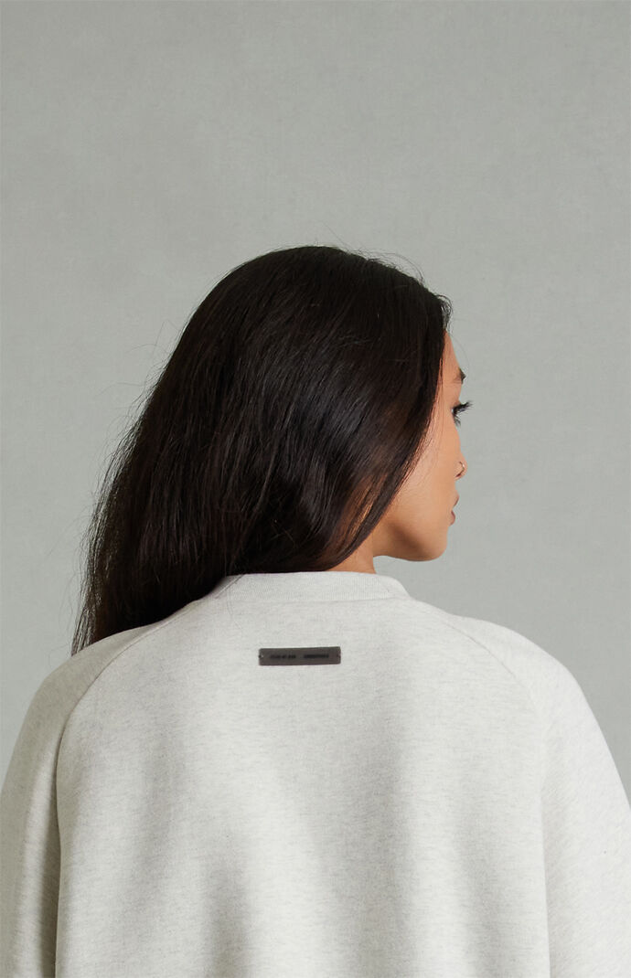 Fear of God ESSENTIALS Women's Heather Oatmeal '90s Embossed Raglan Cropped Crew Neck Sweatshirt