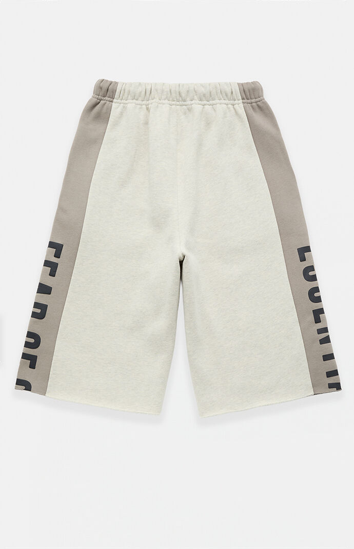 Fear of God ESSENTIALS Vanilla Paneled Raw Cutoff Sweat Shorts