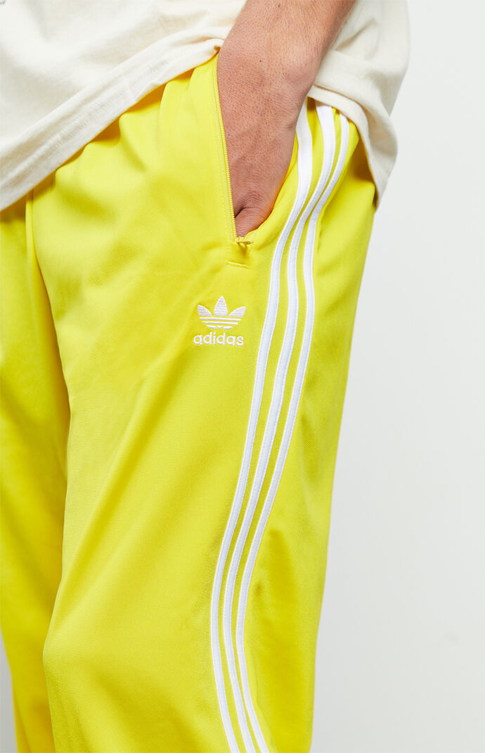 yellow adidas track pants