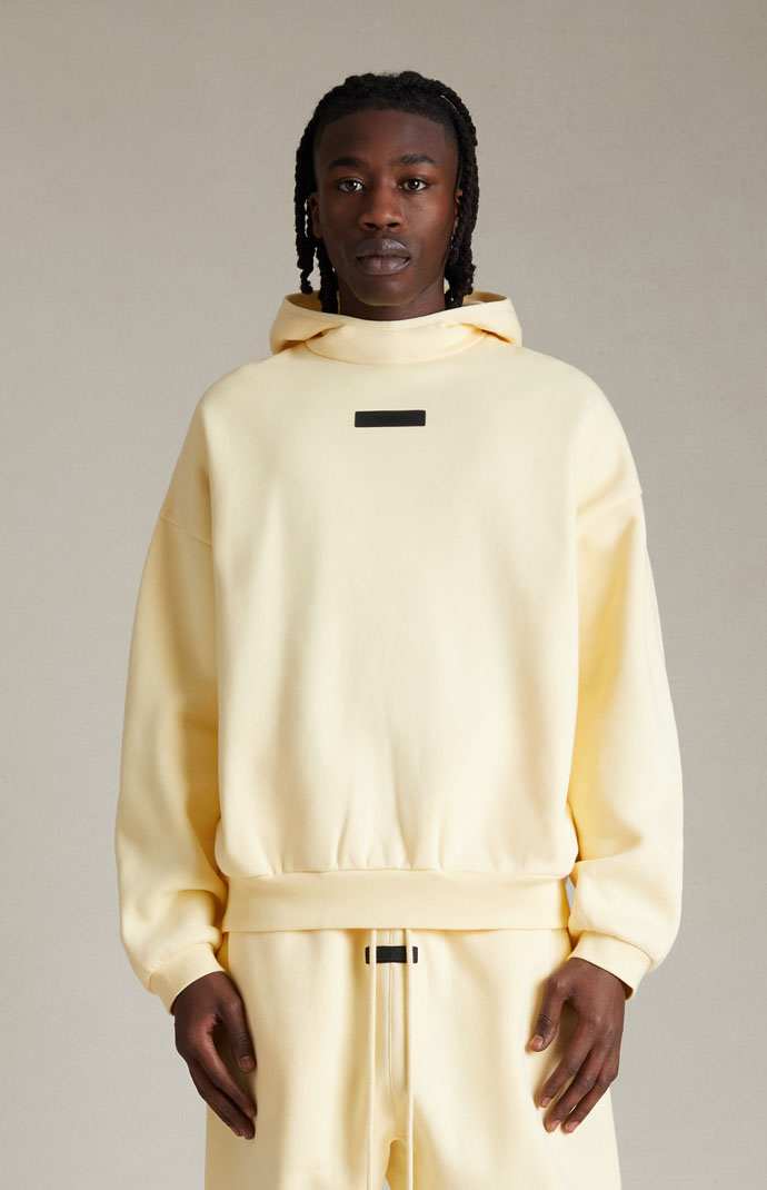Fear of god essentials hot sale yellow hoodie